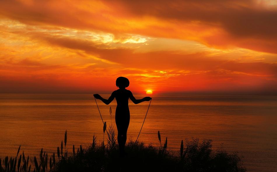 Woman Jumping with Rope at sunset