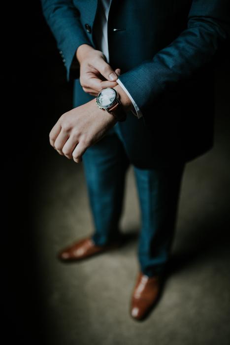 wristwatch on hand of man in formal suit