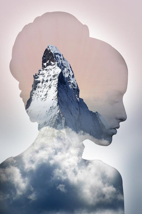 Pink and orange profile portrait of a woman with beautiful, snowy mountains in white clouds