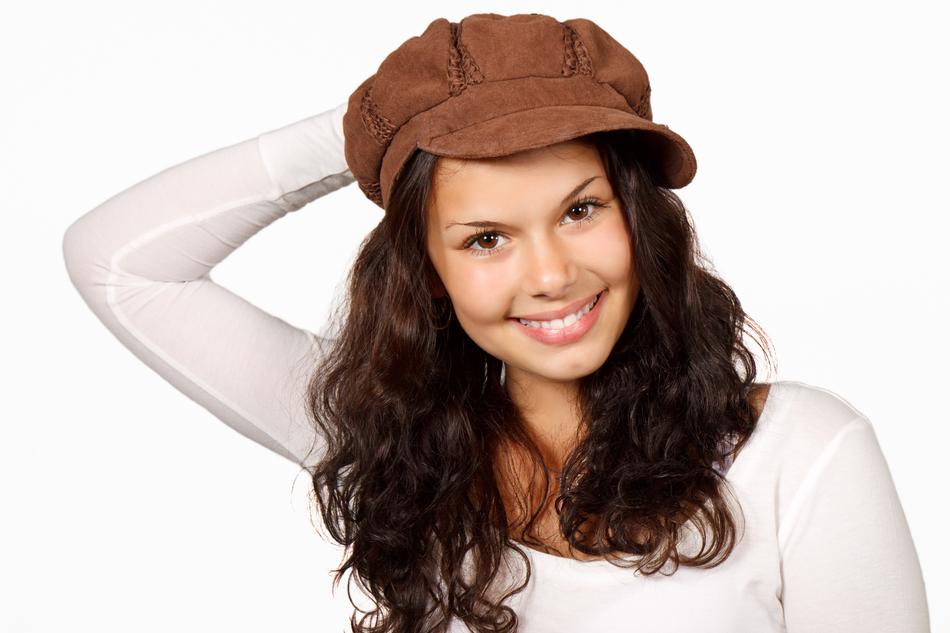 Beautiful happy woman in brown cap