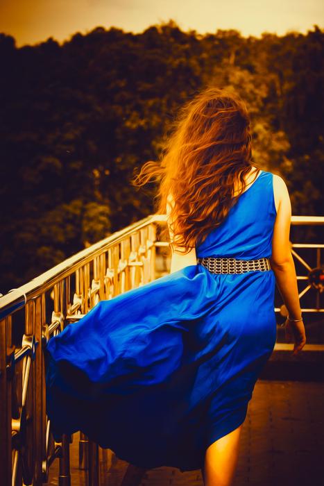 Girl In Blue Dress with Long Hair on the beautiful terrace