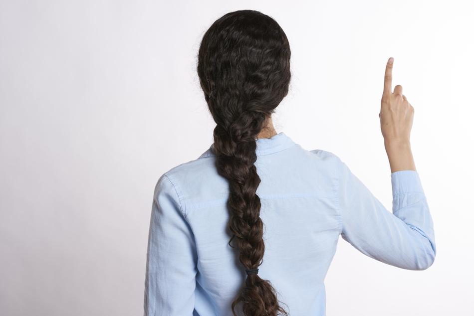 photo of a girl with a long pigtail from the back