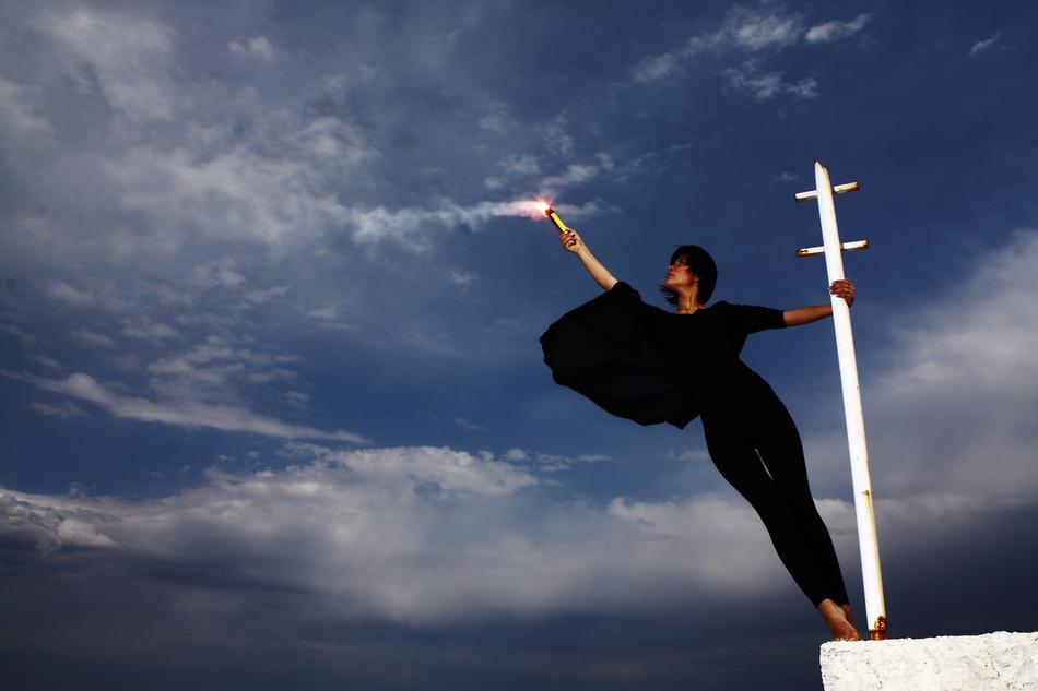 slim woman with torch at sky