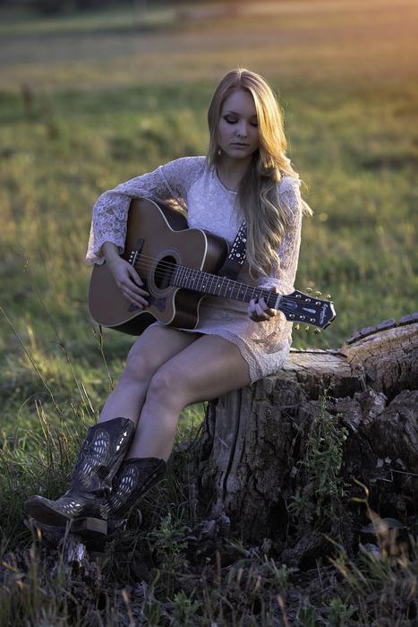 sexy girl plays Guitar in Countryside at dusk