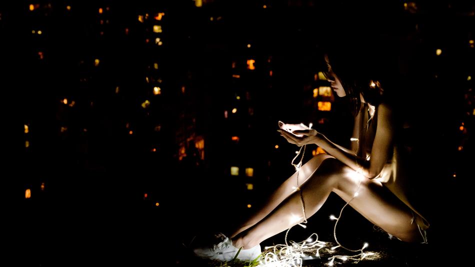 girl in the dark among the lights