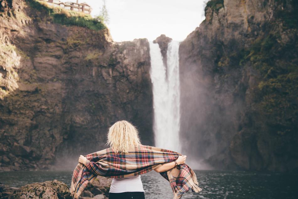 blonde with a scarf on the background of a waterfall