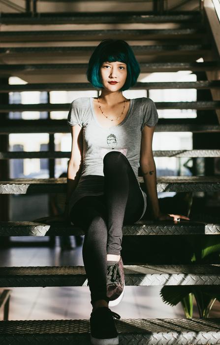 asian girl with blue hair sitting on the steps