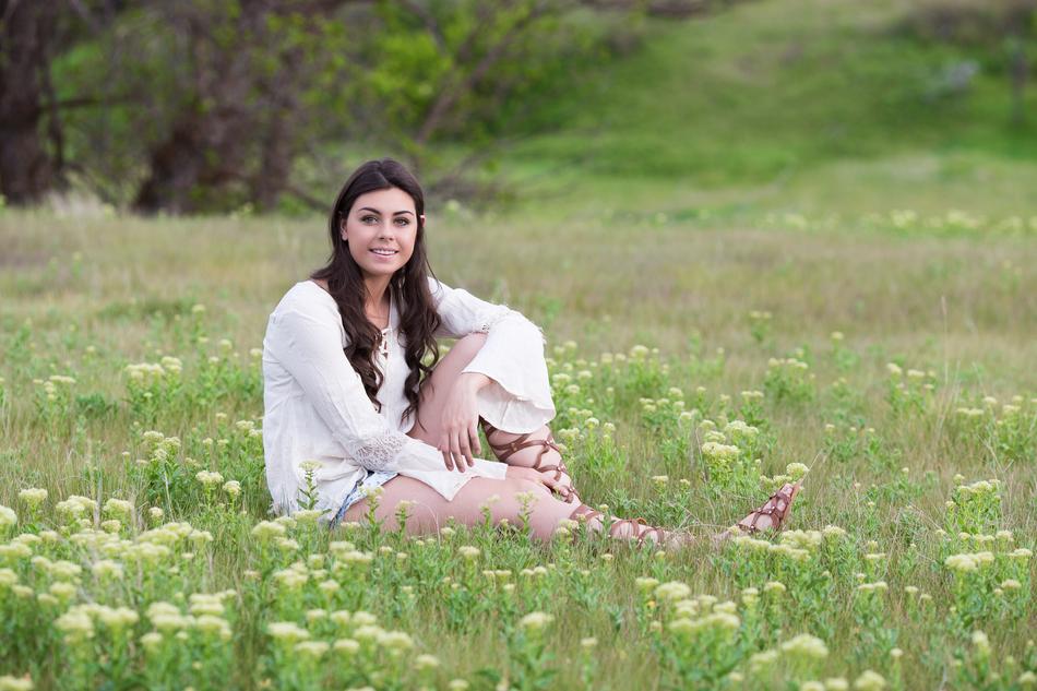 beautiful girl posing on a spring meadow