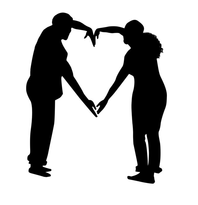 silhouette of a couple, heart from hands