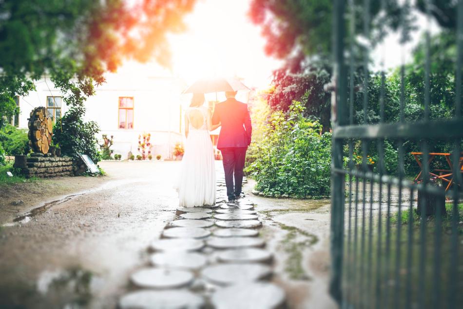 wedding Couple with umbrella on walkpath