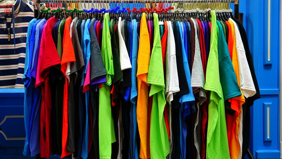Colorful t-shirts, hanging among the blue furniture