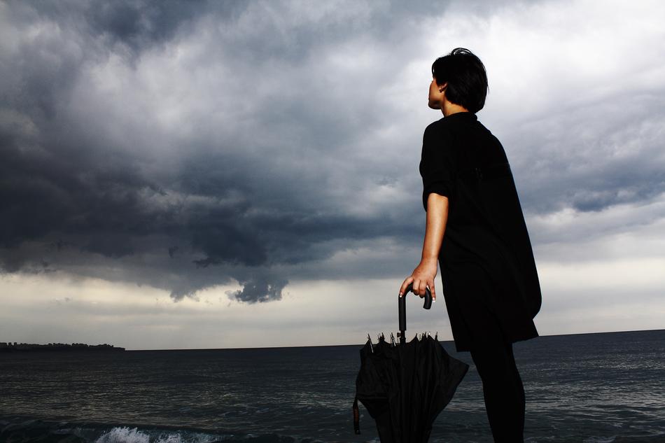 woman with umbrella on beach