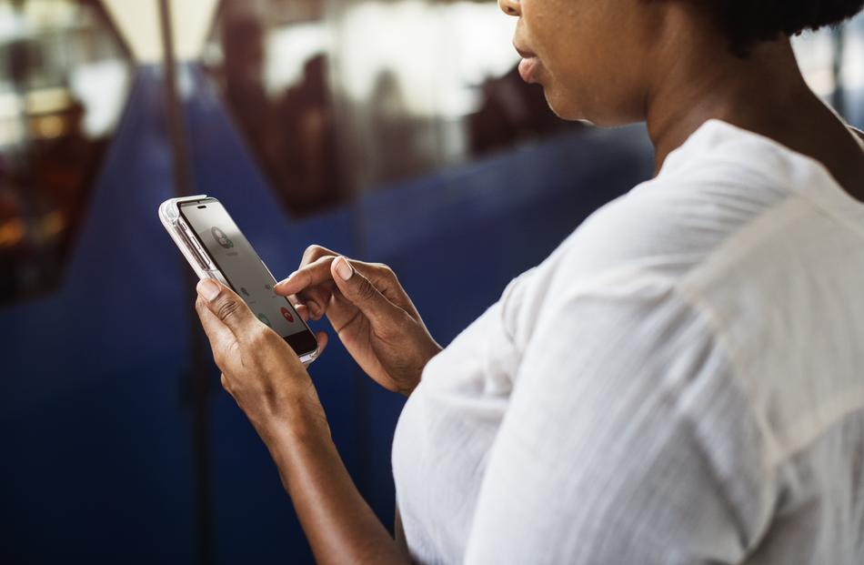 african american woman with phone on blurred background