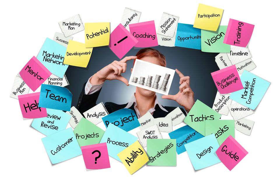 Person, holding card with the chart, among the colorful stickies with the words