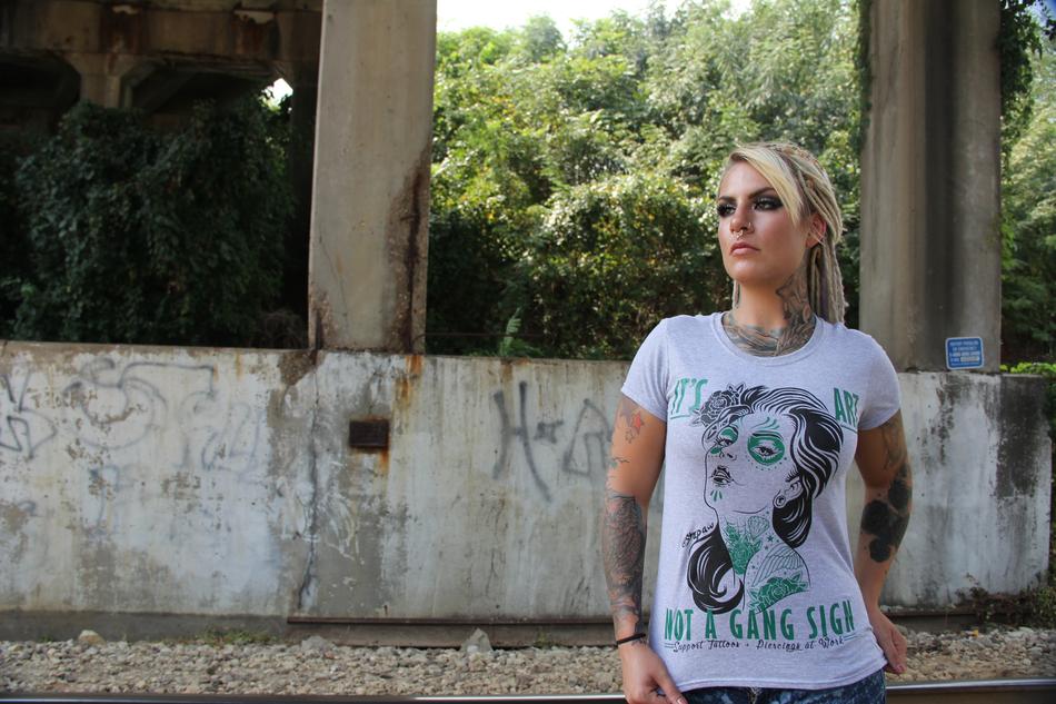 tattooed blonde with dreads on the abandoned building