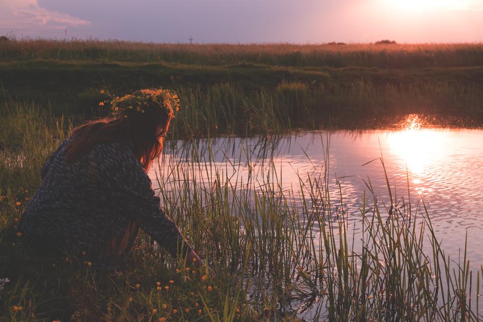 woman by the river at sunset