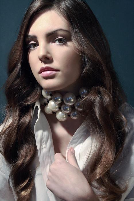 photo of a girl with wavy hair and a beautiful necklace