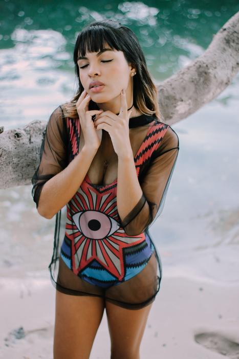 brunette in trendy swimsuit on the beach in brazil