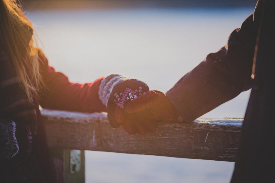 man and woman in warm mittens