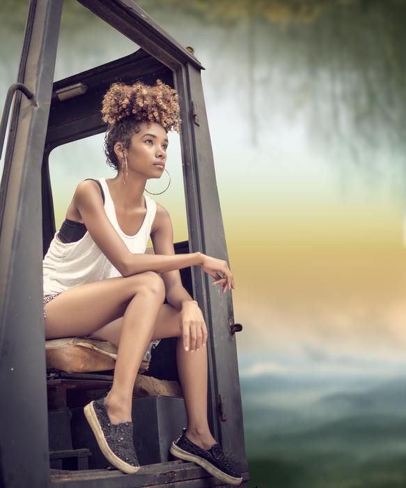 slim curly hair Girl sits in cabin