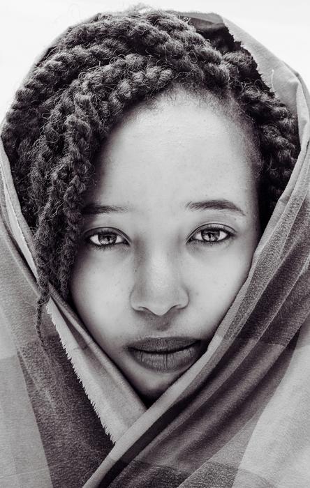 Black and white portrait of the beautiful woman with pigtails, covered in checkered