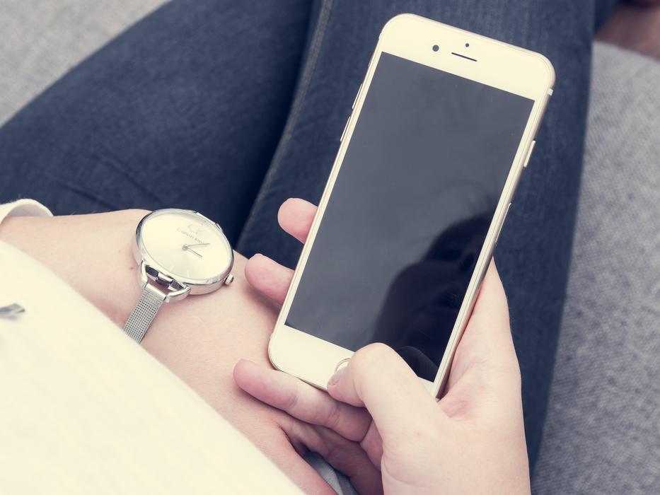 Beautiful, shiny Iphone 6s plus in the hand of the woman, with the wrist wach