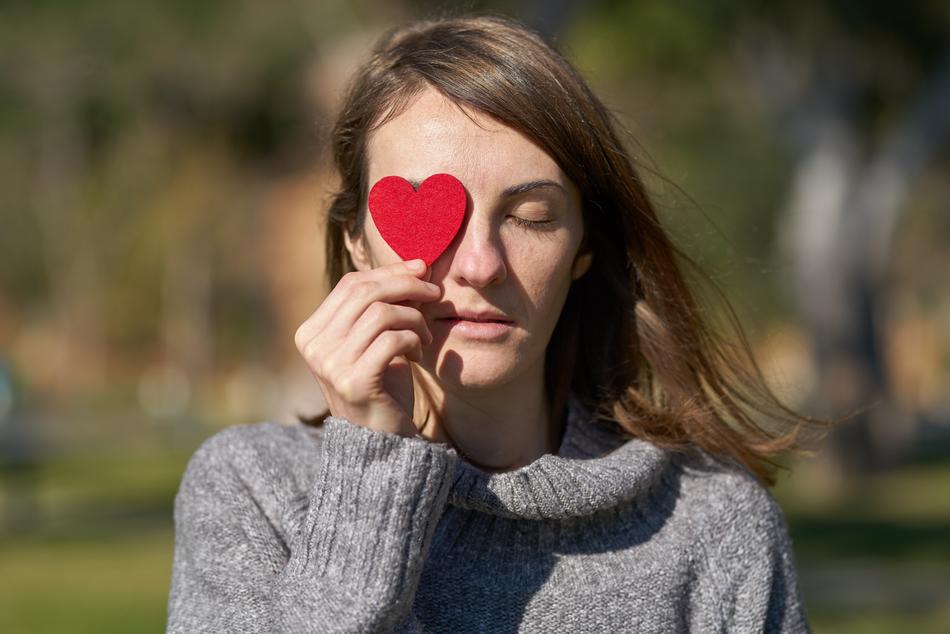 Valentine’s Day Celebration, girl with heart in hand at eye