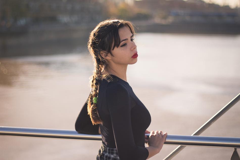 girl with pigtails stands on the deck