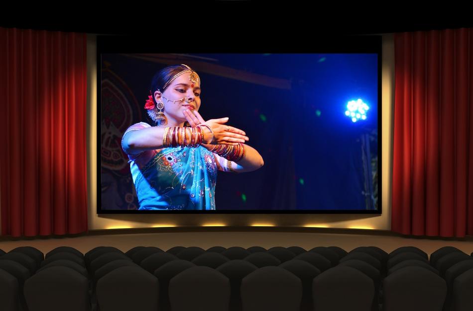 Girl in colorful clothes, on the screen in the cinema, in India