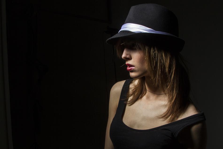 brunette in black tank top and hat