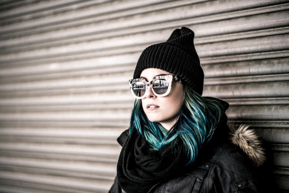young woman with blue hair and black hat