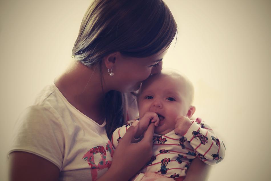 happy mom with toddler in blurred background