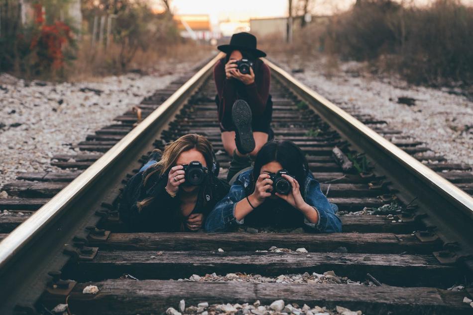 girls with cameras on railway
