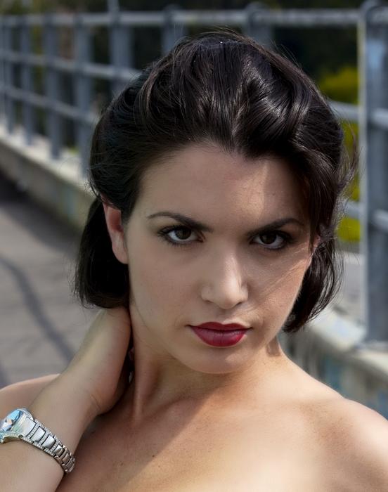 portraits of women against the background of a metal fence