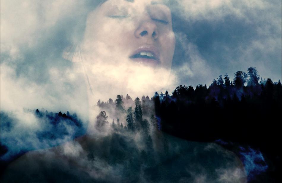 woman’s portrait on the mountain background