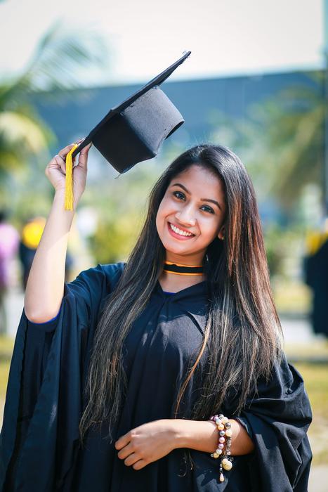 Portrait of the beautiful, smiling girl, with the graduation hat, on the graduation