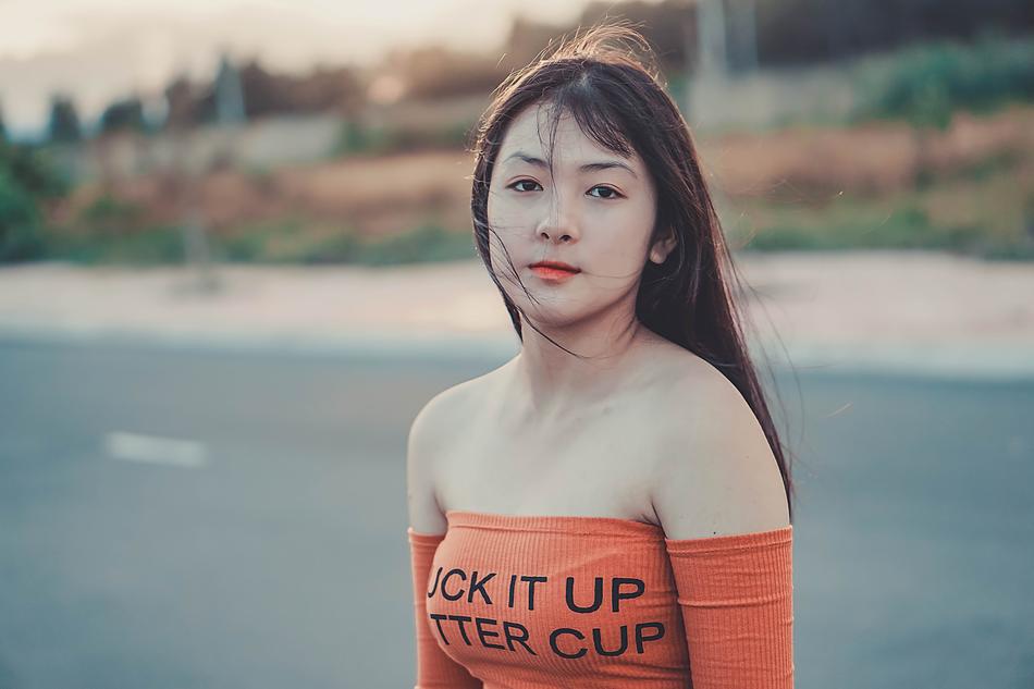 woman stands on the road on a blurred background