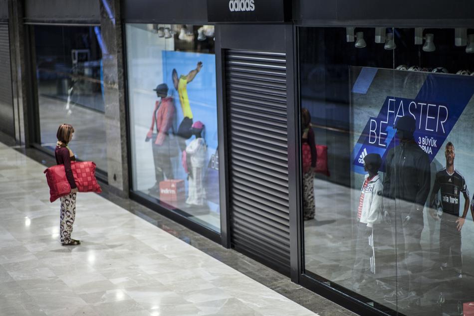 child with a pillow near the shop window