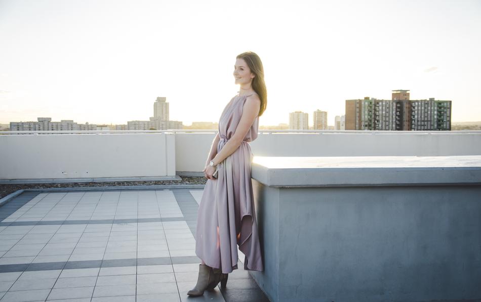 beautiful woman in dress posing on the roof