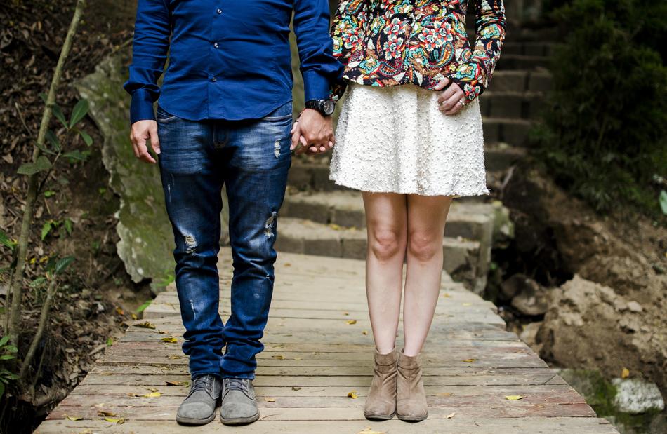 feet of young couple on boardwalk in nature