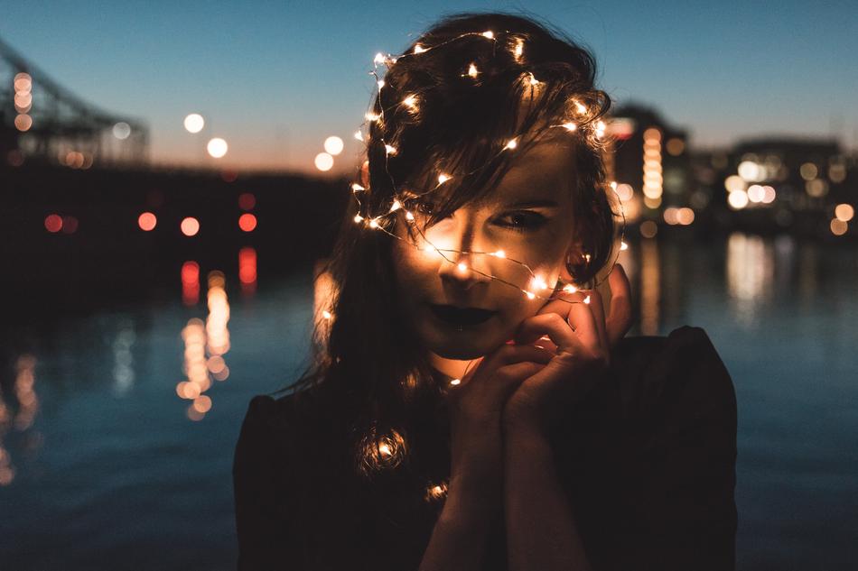 Girl with lights on head at dusk