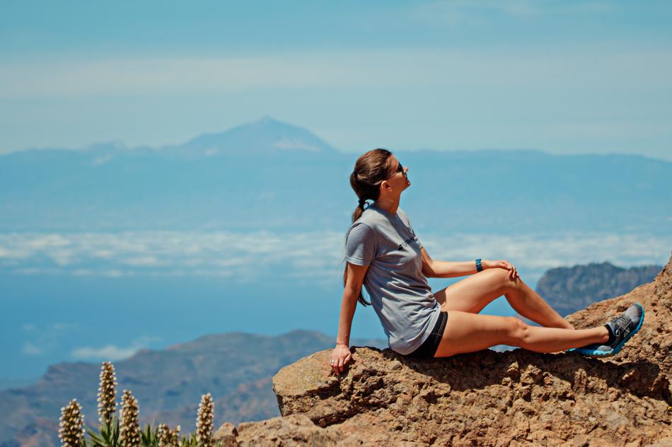 girl on top of the mountain in summer