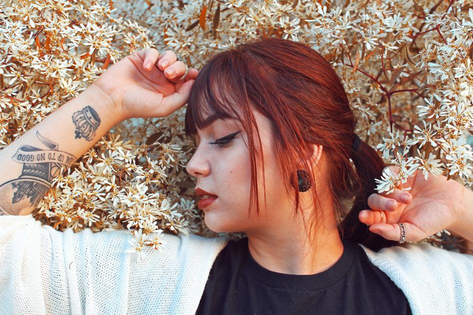 redhead woman with tottooed hand