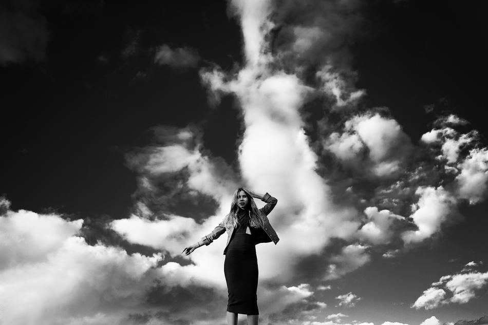 black and white, elegant girl on a background of clouds