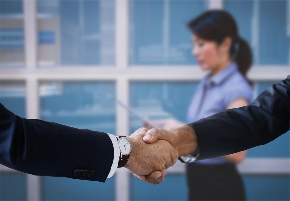 handshake on the background of a woman