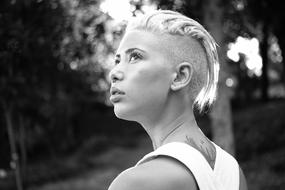Black and white portrait of the blonde girl, among the trees