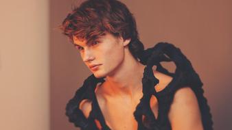 Profile portrait of the young guy, in black costume