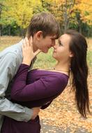 students in love on the background of an autumn park