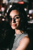 portrait of a girl with glasses on a blurred background