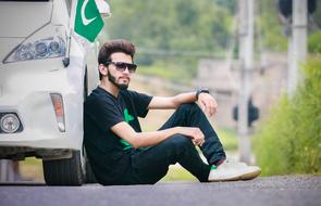 a young man sitting by the bus